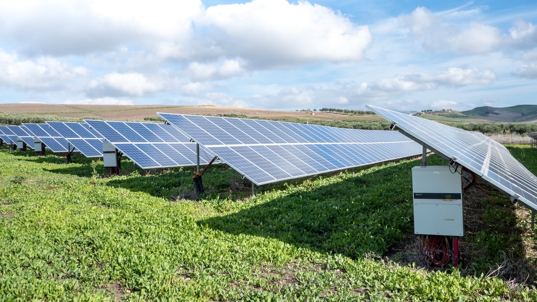 Solar technician installing rooftop panels
